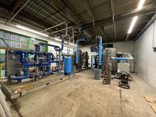 industrial facility with compressed air system compressors and piping