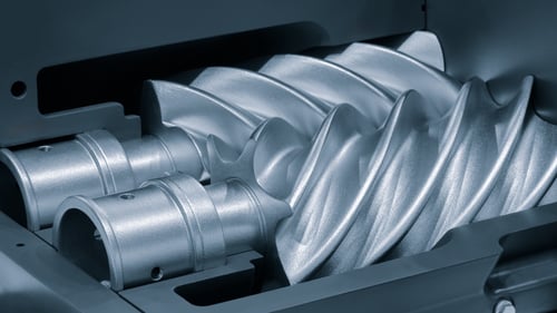 shiny silver gears with spiral inside a compressor