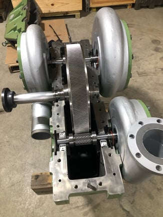 A partially reassembled centrifugal compressor showcasing the large, cleaned bullgear, and pinion gears.
